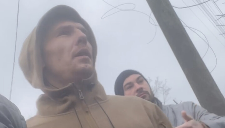 Raiders taking away phones from UOC believers. Photo: UOJ